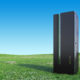 Modern Server Rack on a Beautiful green landscape with clear blue sky stock photo